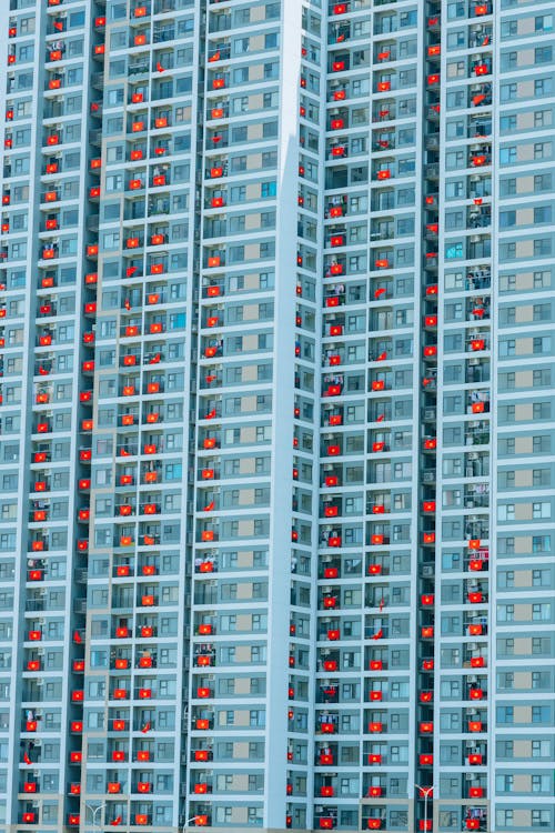 White Concrete Building with Red  Flags 