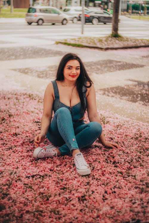 Woman in Denim Tank Top and Pants Sitting on the Floor
