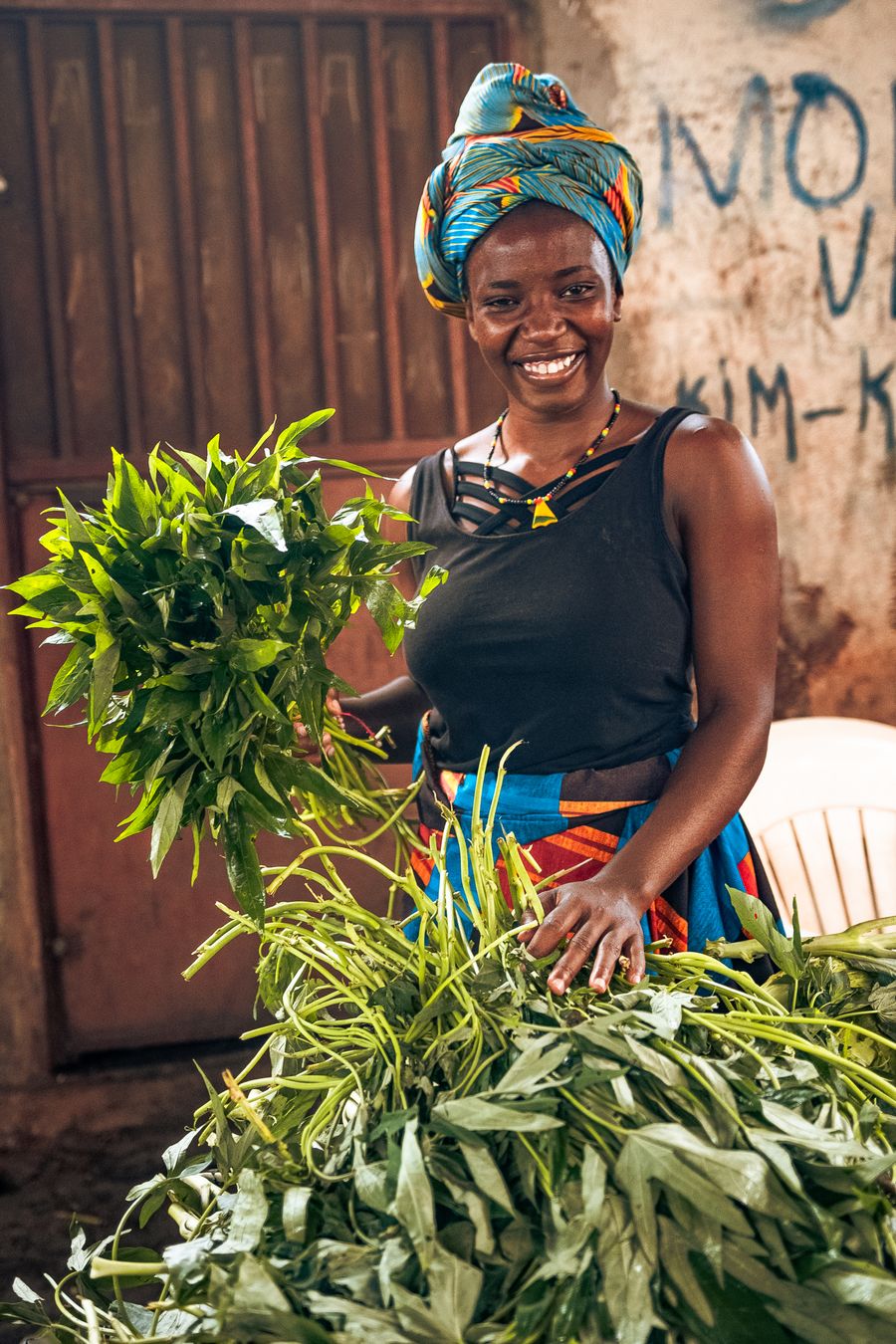 Local shop owner packing fresh greens at their market stall