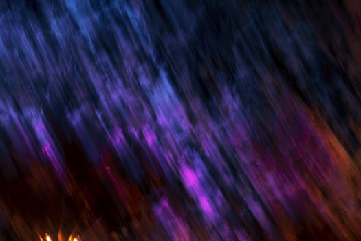 A dynamic abstract image featuring colorful blurred motion in hues of purple and blue, creating a vibrant artistic background.