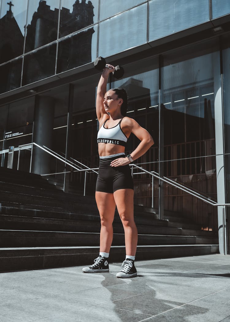 A Woman Lifting A Dumbbell