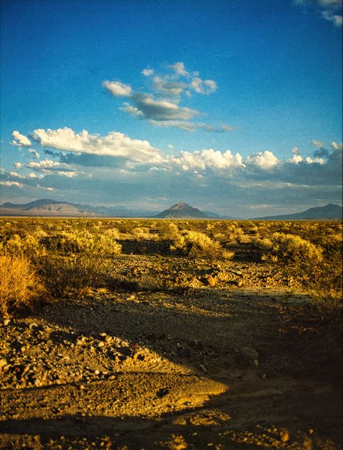 Free Stunning desert landscape in Death Valley under a vibrant blue sky with scattered clouds. Stock Photo