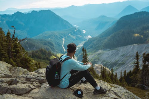 Free Photo of Man Looking at Mountain Landscape Stock Photo