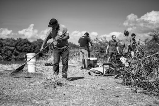 A group of volunteers engaging in environmental cleanup near a river.