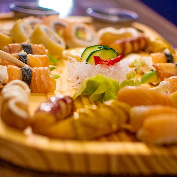 Shredded Radish And Slices Of Cucumber On A  Tray Of Sushi