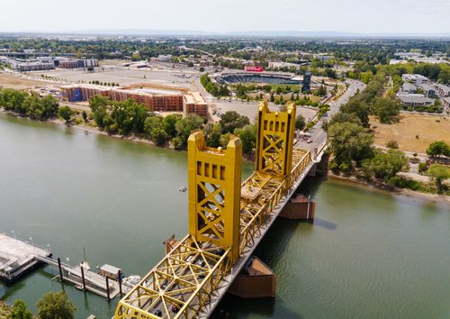 Free A stunning drone view of Sacramento's golden Tower Bridge spanning the river. Stock Photo