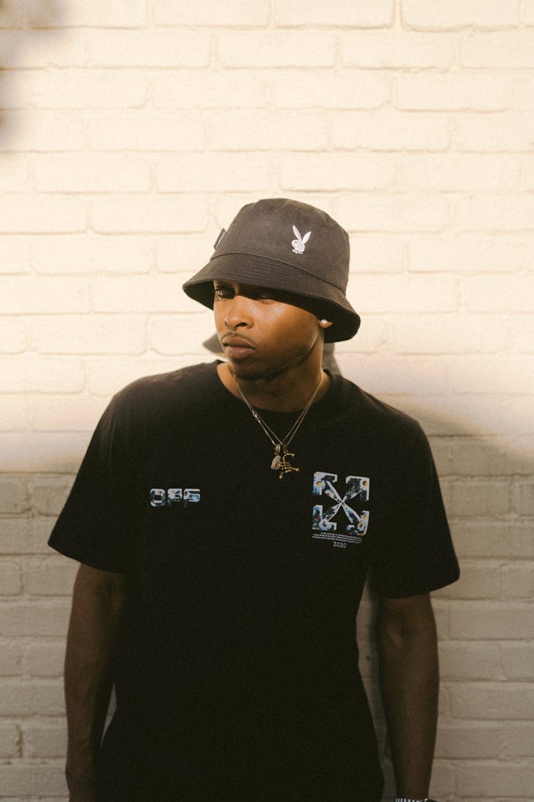 Young Man In Black Hat And T-shirt