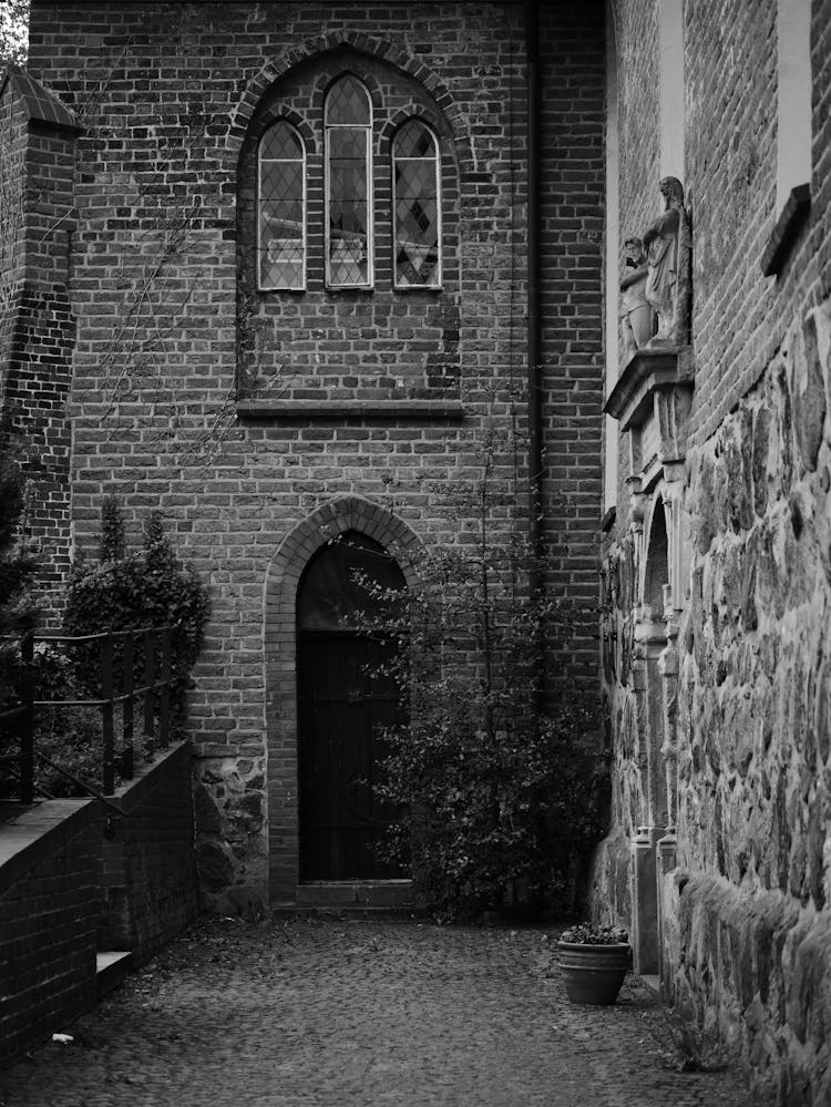 Grayscale Photo Of A Brick Building