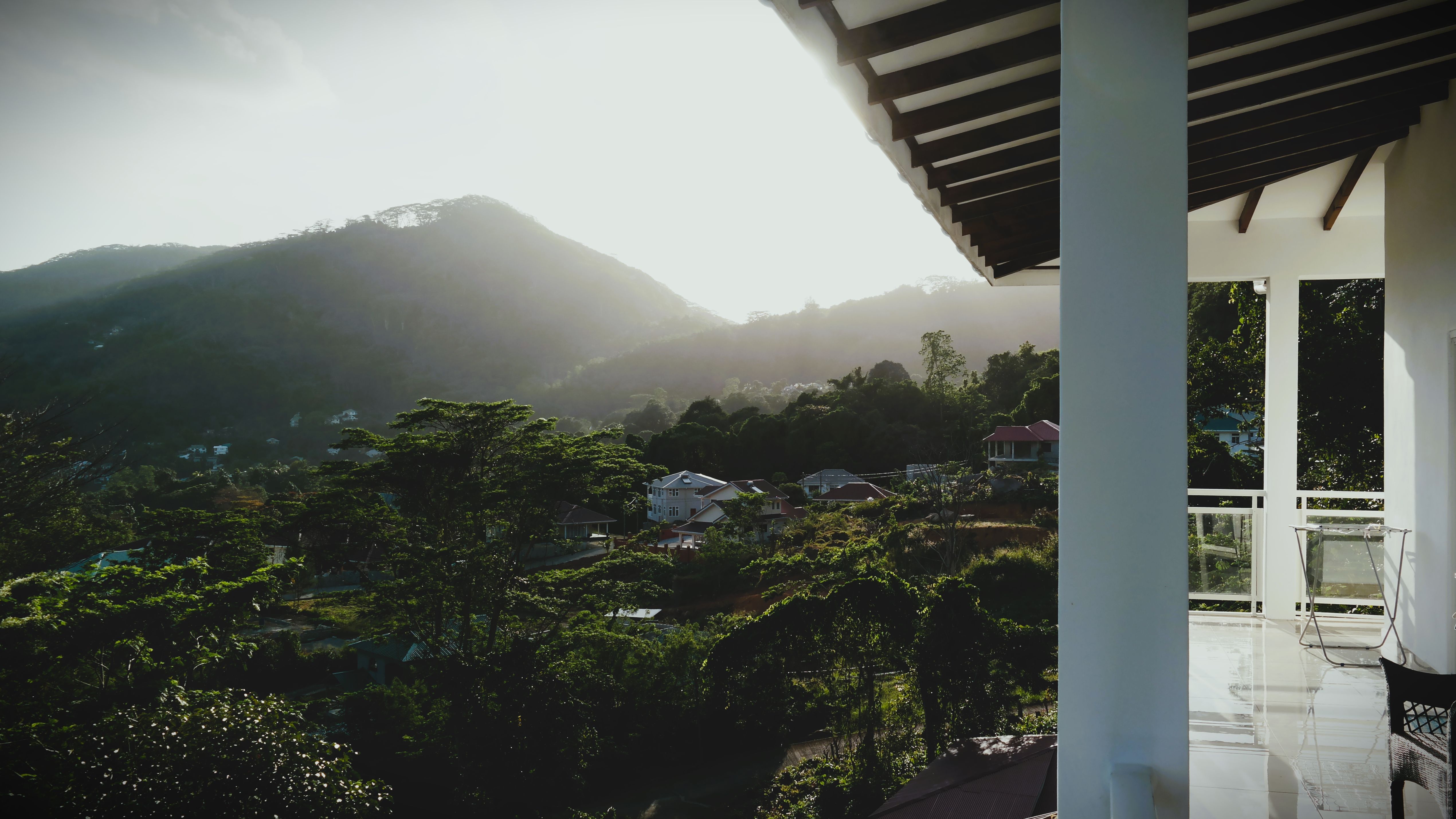 View from a private balcony across a wide green mountain valley