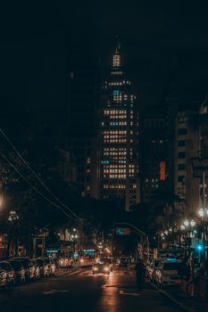 A dramatic night view of São Paulo city featuring the illuminated Banespa Building.