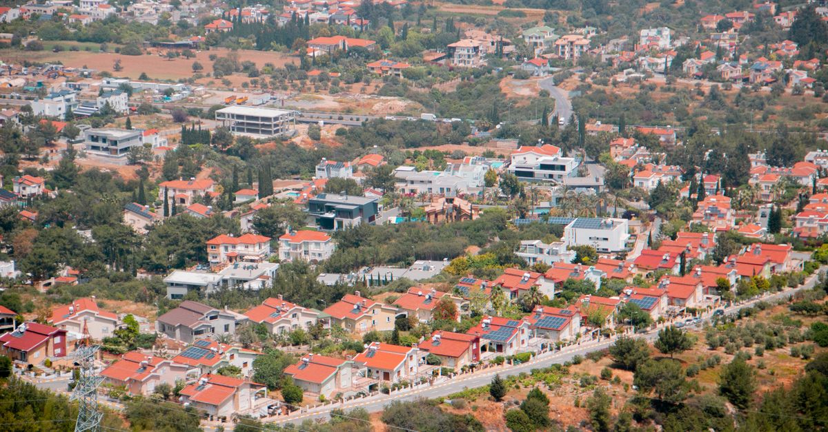 A panoramic aerial view of Girne, showcasing the city's unique architecture and red-roofed houses.