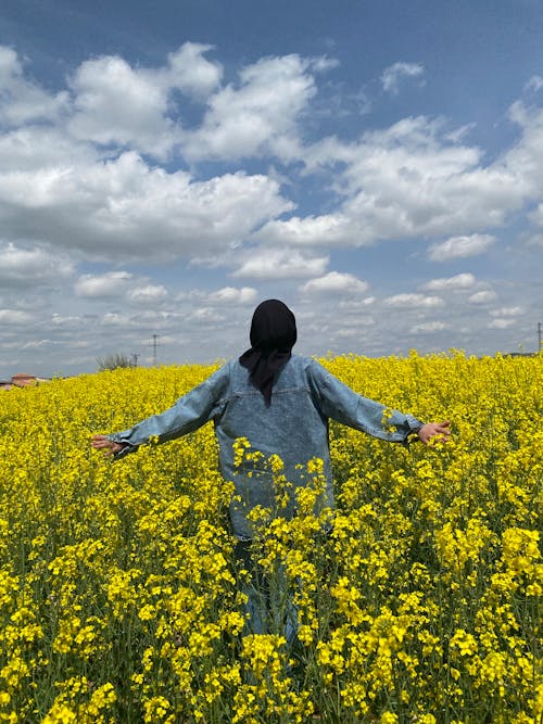 Woman in Denim Jacket Standing in the Flower Field
