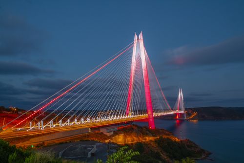 Free Illuminated Yavuz Sultan Selim Bridge spans the Bosphorus Strait at dusk, showcasing stunning architectural design. Stock Photo