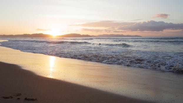 Capture of a breathtaking sunrise on San Vicente Beach, featuring golden sand and gentle waves.