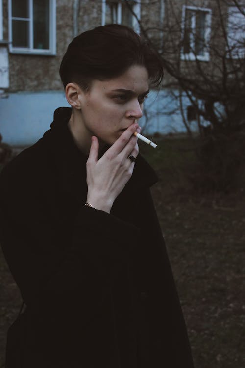 Man in Black Coat Smoking Cigarette