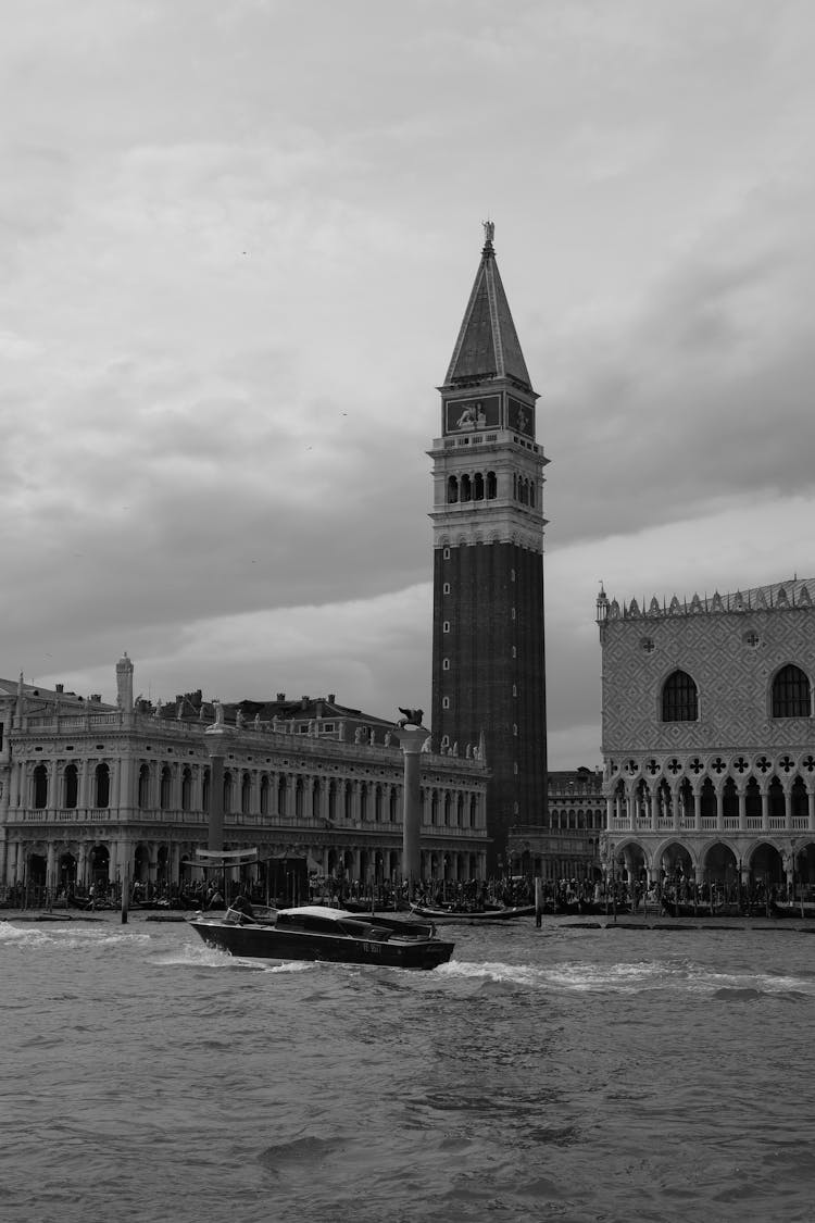 Boat On River And Tower In City