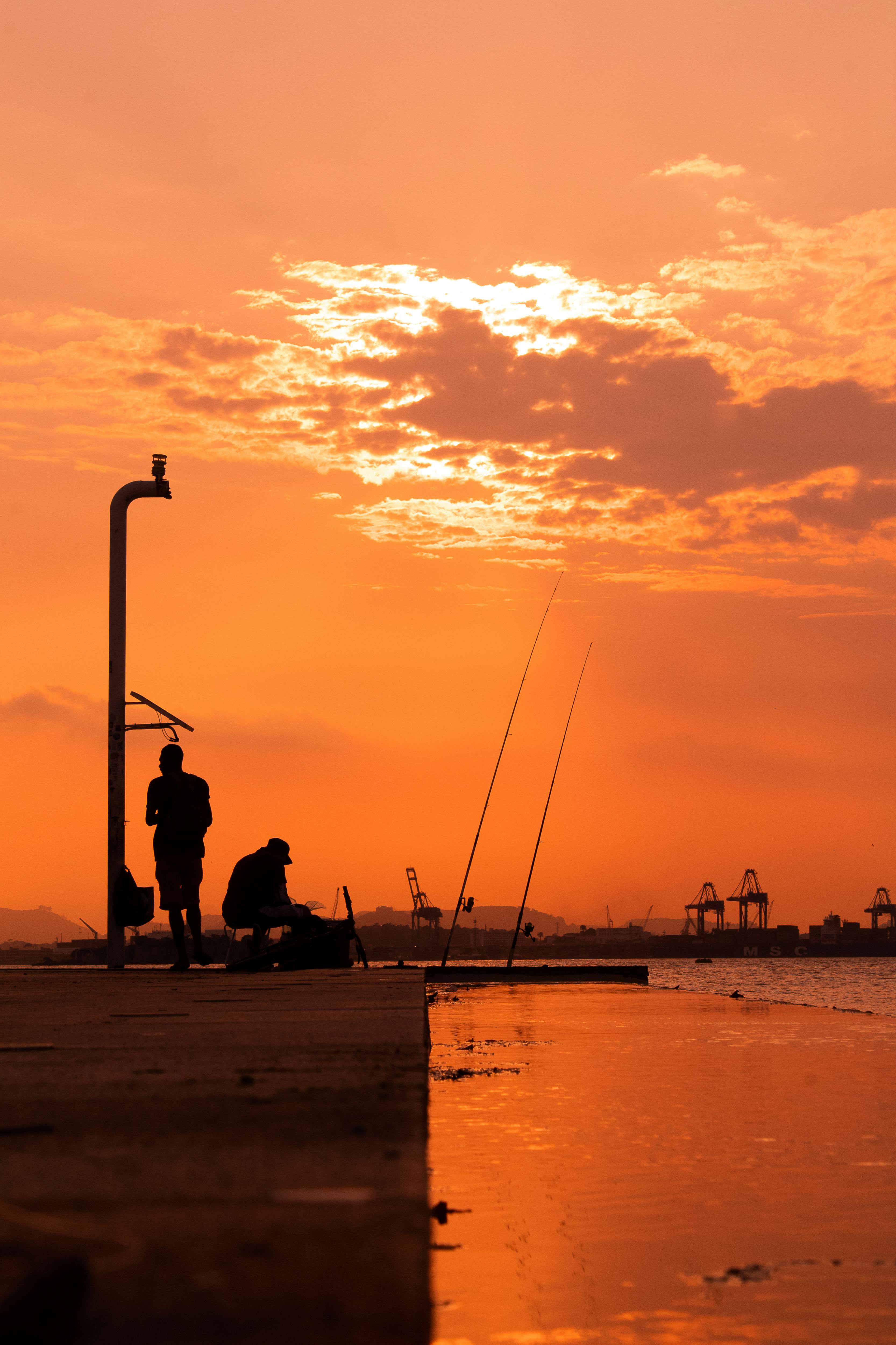 fishermen at the back of the museum of tomorrow in rio de janeiro