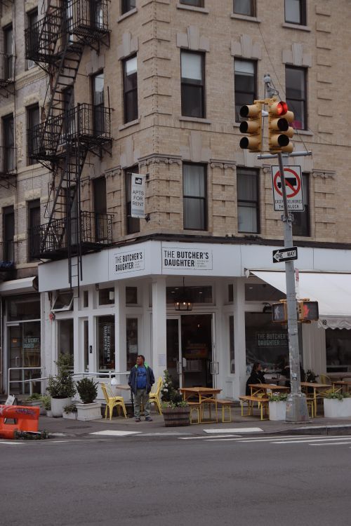 Free Charming corner cafe in bustling urban setting with classic architecture. Stock Photo