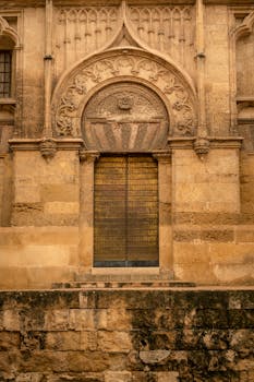 Intricate stonework entrance of a Roman Catholic cathedral in Córdoba, Spain.