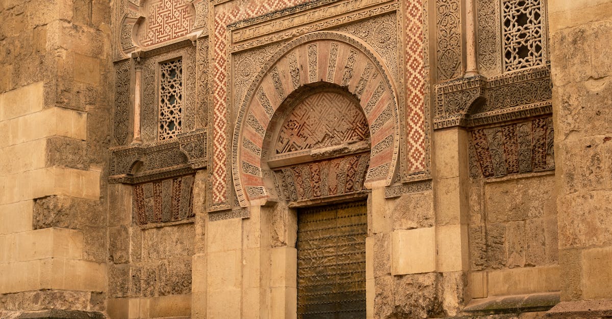 Intricate stone facade at Mezquita de Córdoba, showcasing Moorish architecture.