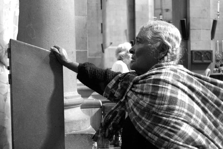 Photo Of Old Woman Standing In A Church 