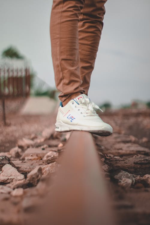 Free Person in Brown Pants and White Nike Sneakers Stock Photo