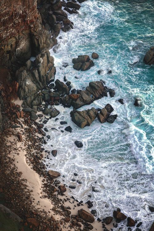 A High Angle Shot of Ocean Waves Crashing on Rocky Shore · Free Stock Photo