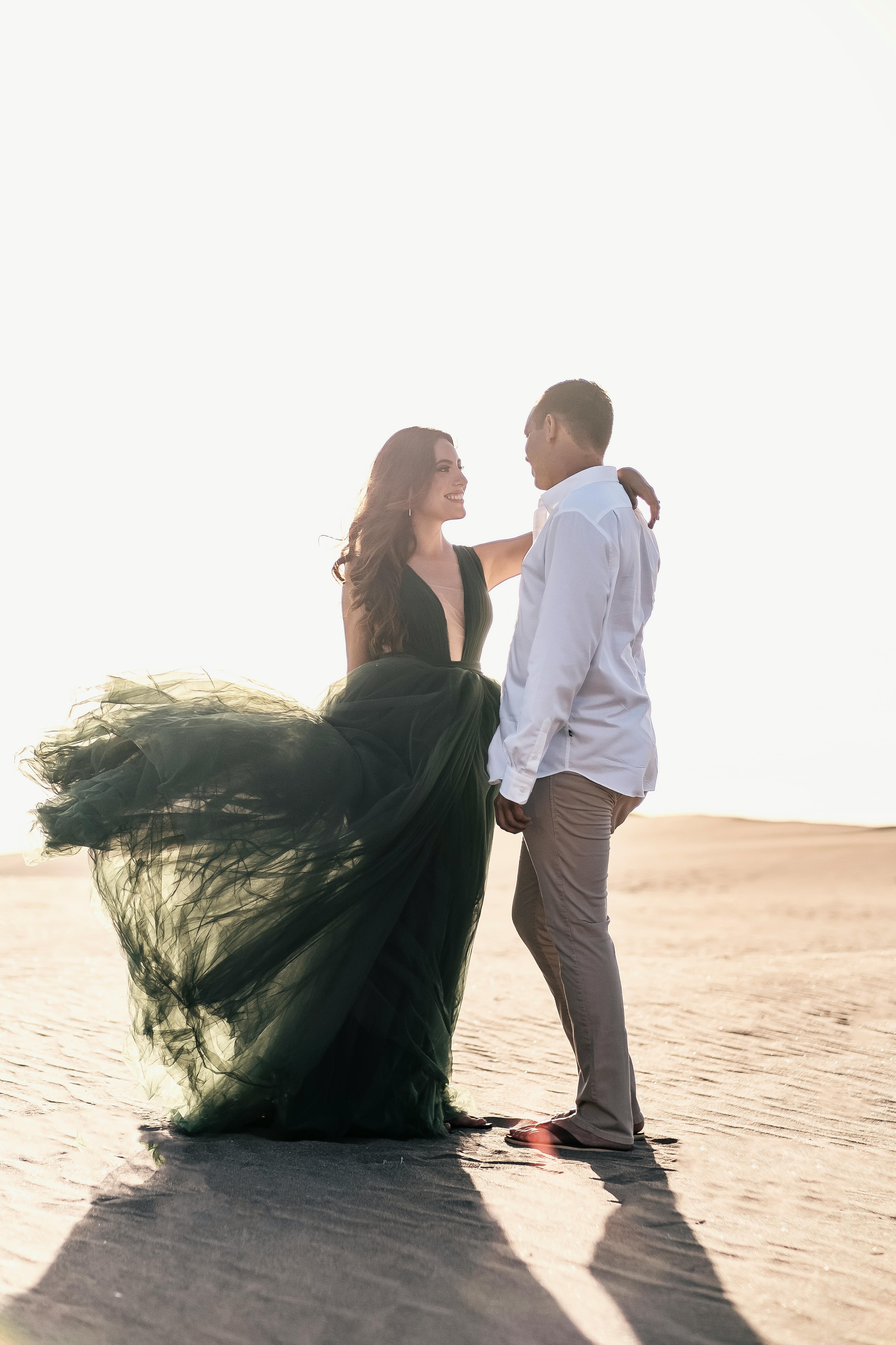 young couple standing face to face on the beach