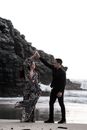 A Couple Holding Hands Up in the Air 