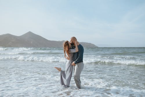 Couple Standing in the Sea and Kissing