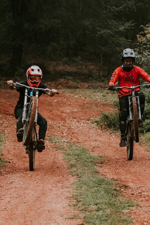 Two People Biking on a Dirt Road