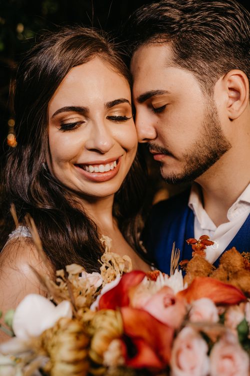 Free Loving couple sharing an intimate moment with a colorful floral arrangement. Perfect portrait for love and romance themes. Stock Photo