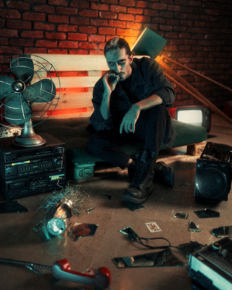 Man Smoking Cigarette In Dark Studio