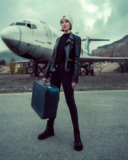 A Woman Carrying a Suitcase