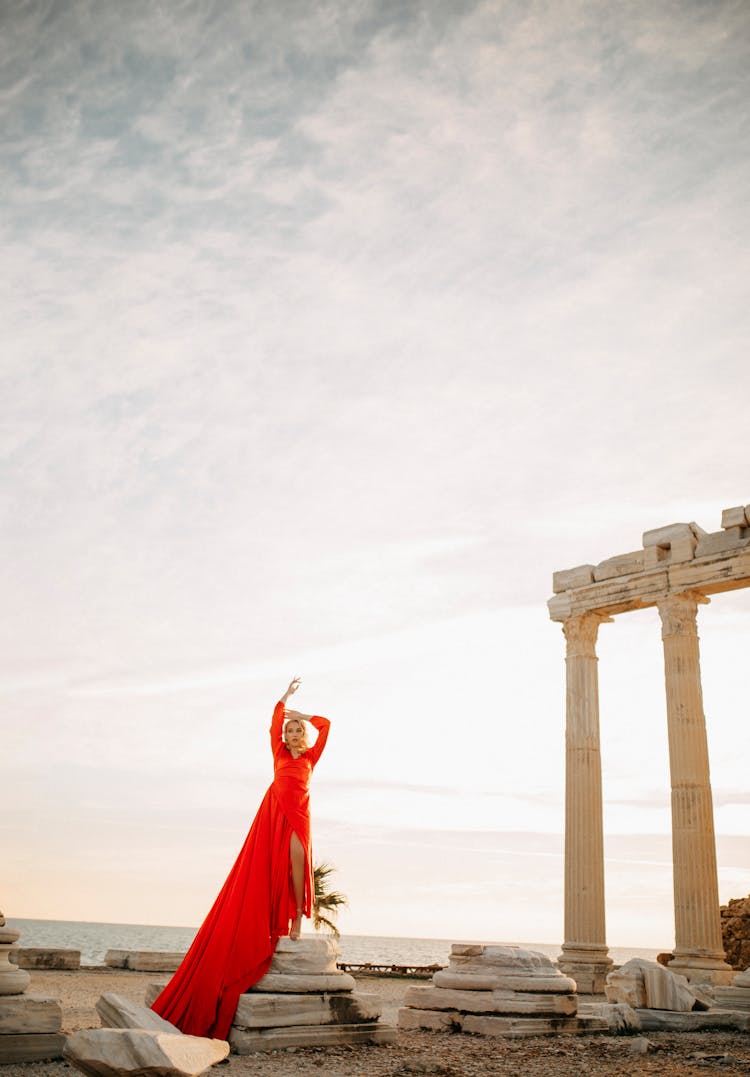 Woman In Red Dress Posing Near Temple Of Apollo 