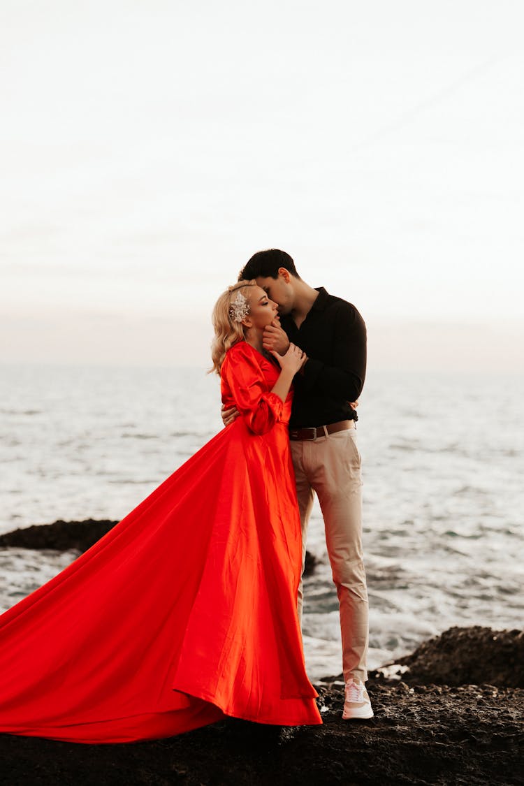 A Romantic Couple Standing On The Beach