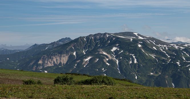 Breathtaking view of a mountain with snow-capped peaks under a clear sky.