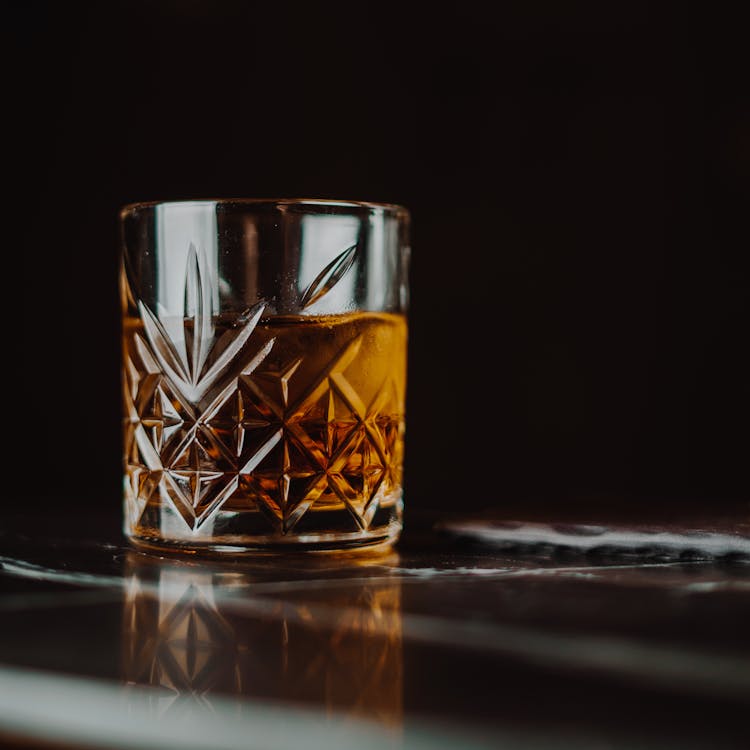 Free Clear Shot Glass on Black Table Stock Photo