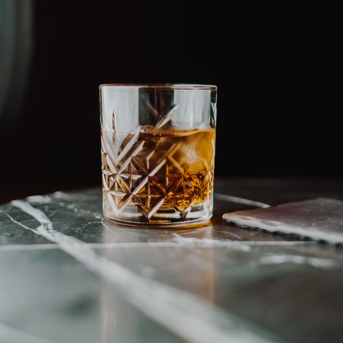 Free A classic glass of whiskey on a marble table with a dark background. Stock Photo
