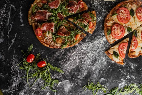 Pizza With Tomato and Green Leaves