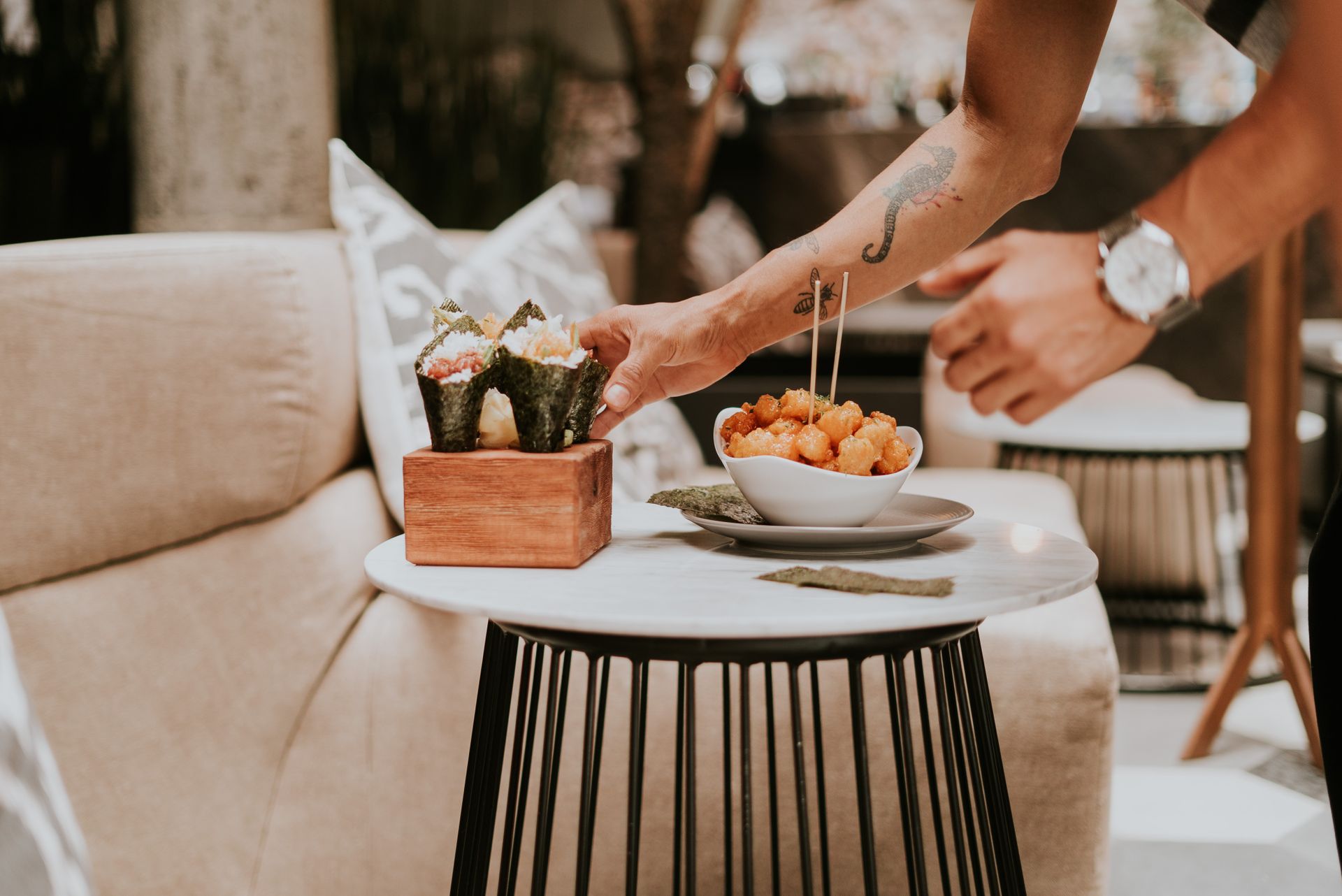 Stylish Japanese hand rolls and crispy tots served in a modern restaurant setting, ideal for a fresh dining experience.