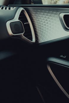 Close-up view of a stylish car dashboard featuring geometric patterns and sleek design.