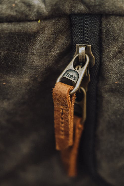 A Zipper with Brown Leather Zipper Pull in Close-up Shot