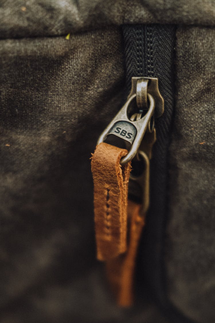 A Zipper With Brown Leather Zipper Pull In Close-up Shot