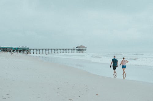 Free 2 Women Walking on Beach Stock Photo
