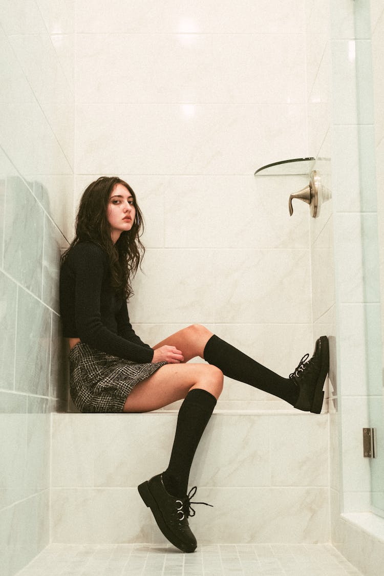 Girl In Black Clothing Sitting In Bathroom