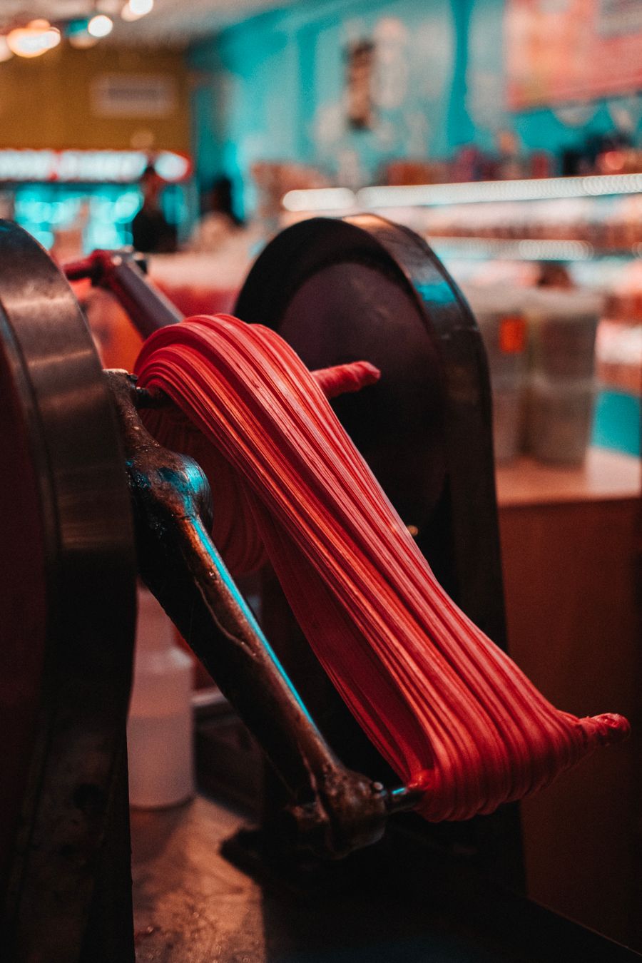 Red sugar being spun on a machine