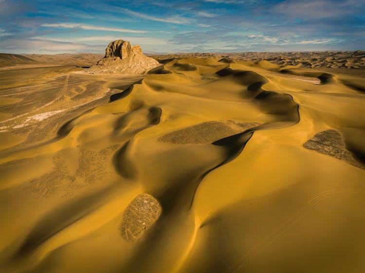 Sand Dunes And Rock Formations In The Kumtag Desert, China