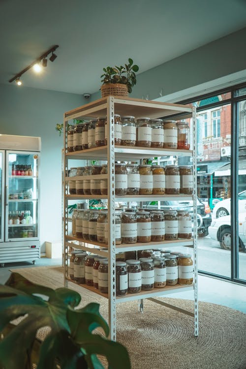 White Wooden Shelves With Glass Jars