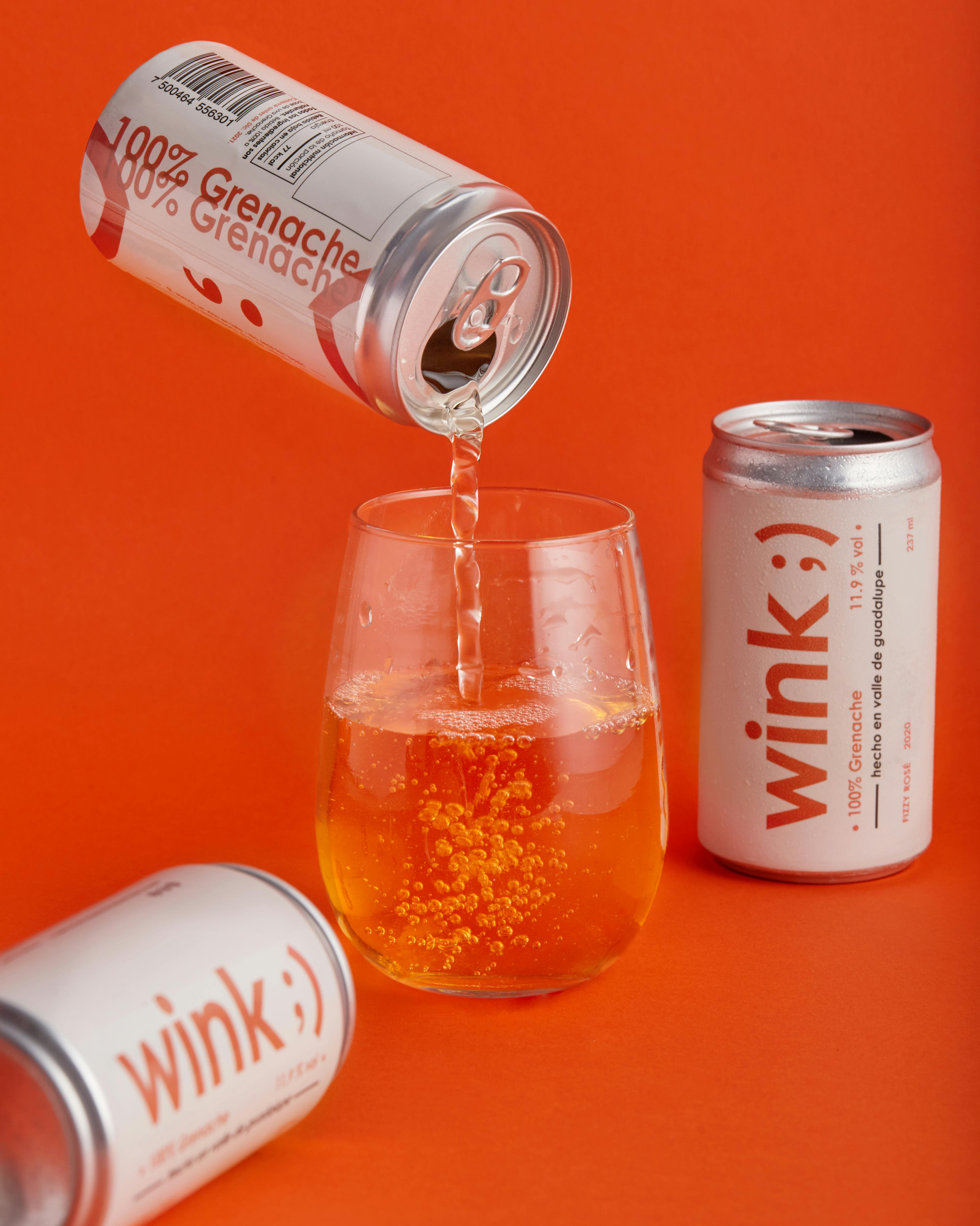 a can of grenache wine being poured into a glass